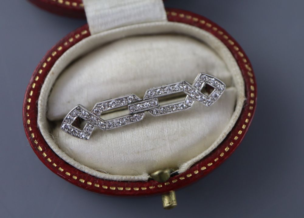 A 1920s white metal and diamond set openwork brooch, 31mm, gross 2.8 grams, with a Tessier box.